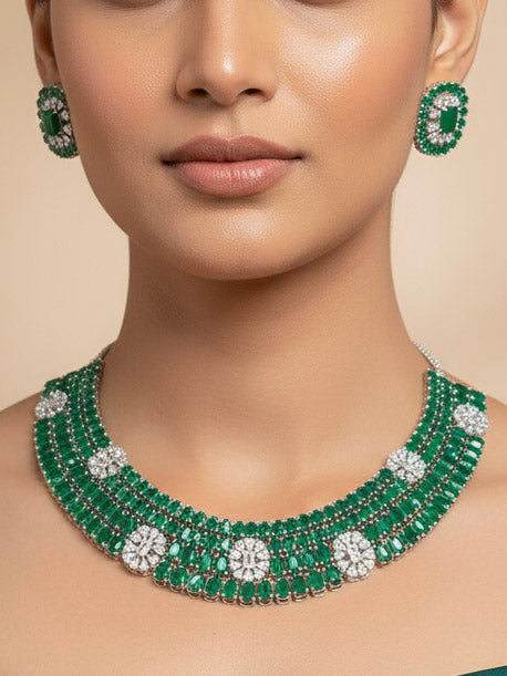 "A bride-to-be wearing an exquisite artificial diamond and green colored stone  necklace and matching earrings, designed for the perfect engagement look. This stunning artificial diamond jewelry set offers luxury and sophistication while being an affordable alternative to natural diamonds."