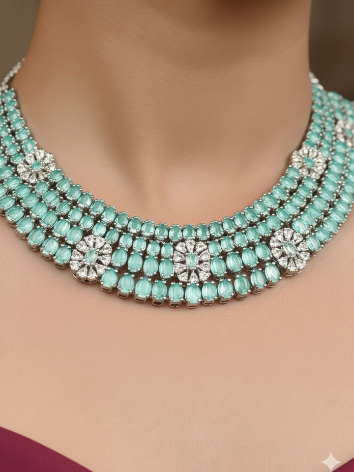 "Elegant woman wearing a luxurious artificial diamond necklace with mint green colored stone with matching earrings, perfect for high-profile wedding receptions and formal galas. This high-end artificial diamond jewelry set combines style, elegance, and affordability for special occasions."
