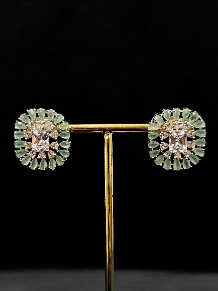 "An exquisite artificial diamond necklace with mint green colored stone and matching earrings, designed for the perfect engagement look. This stunning artificial diamond jewelry set offers luxury and sophistication while being an affordable alternative to natural diamonds." Reception-ready look featuring a statement American diamond jewelry set.
