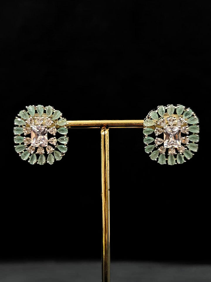 "An exquisite artificial diamond necklace with mint green colored stone and matching earrings, designed for the perfect engagement look. This stunning artificial diamond jewelry set offers luxury and sophistication while being an affordable alternative to natural diamonds." Reception-ready look featuring a statement American diamond jewelry set.