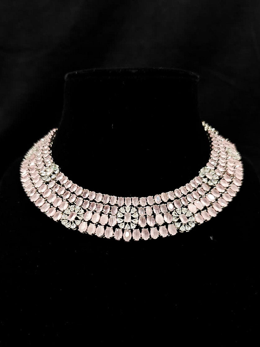 "A glamorous artificial diamond necklace with mint pink colored stone paired with chic earrings, perfect for bridal wear. This high-quality artificial diamond jewelry set is the ideal choice for modern brides looking for a budget-friendly option with timeless sparkle." Reception-ready look featuring a statement American diamond jewelry set.
