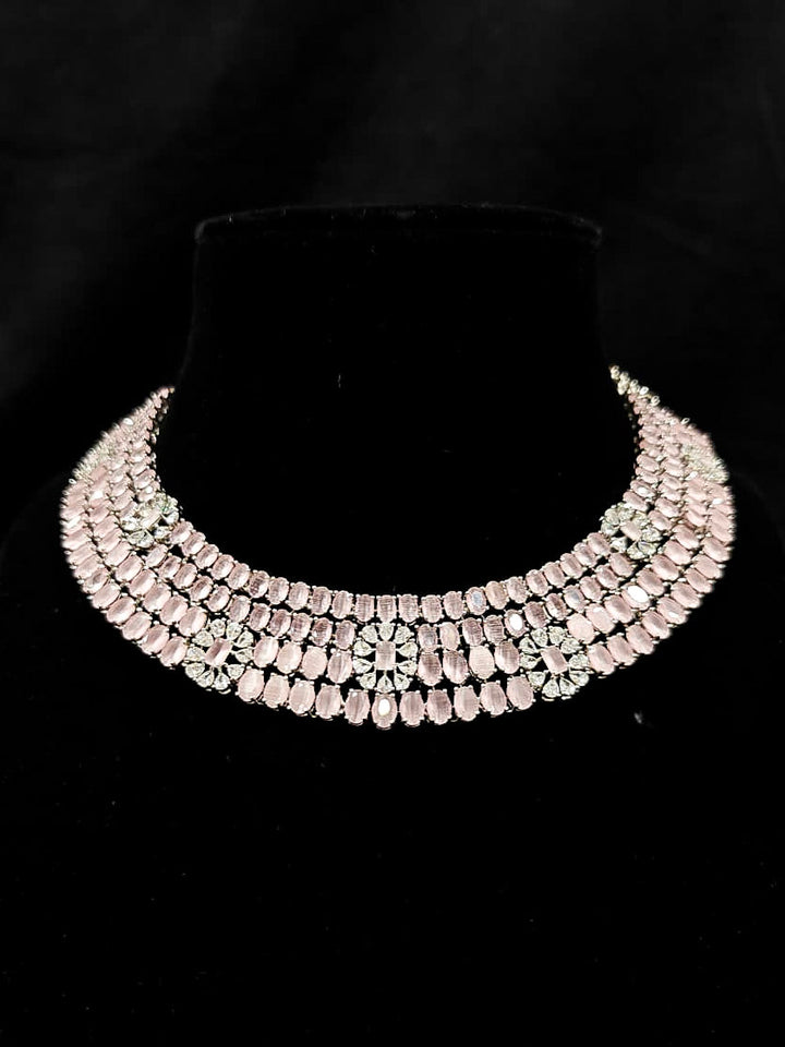 "A glamorous artificial diamond necklace with mint pink colored stone paired with chic earrings, perfect for bridal wear. This high-quality artificial diamond jewelry set is the ideal choice for modern brides looking for a budget-friendly option with timeless sparkle." Reception-ready look featuring a statement American diamond jewelry set.