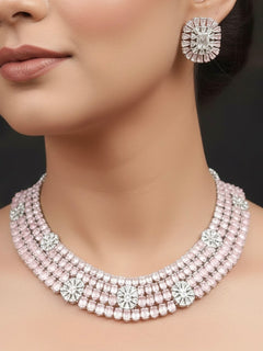 "A stunning woman wearing a glamorous artificial diamond necklace with mint pink colored stone paired with chic earrings, perfect for bridal wear. This high-quality artificial diamond jewelry set is the ideal choice for modern brides looking for a budget-friendly option with timeless sparkle."
