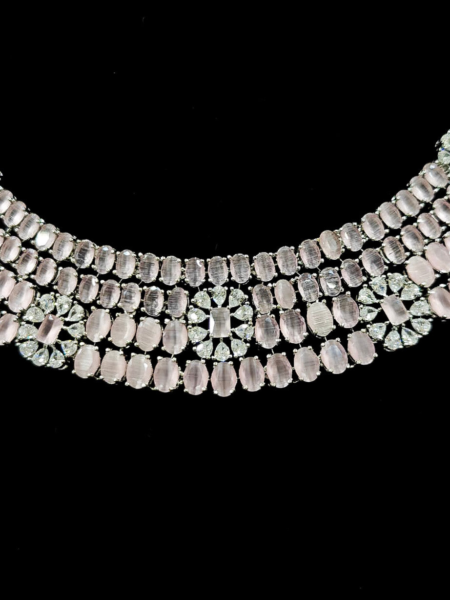"A glamorous artificial diamond necklace with mint pink colored stone paired with chic earrings, perfect for bridal wear. This high-quality artificial diamond jewelry set is the ideal choice for modern brides looking for a budget-friendly option with timeless sparkle." Reception-ready look featuring a statement American diamond jewelry set.