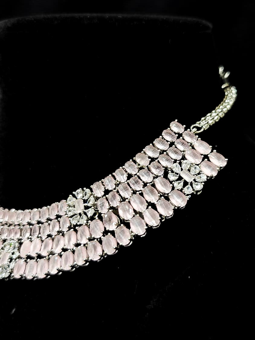 "A glamorous artificial diamond necklace with mint pink colored stone paired with chic earrings, perfect for bridal wear. This high-quality artificial diamond jewelry set is the ideal choice for modern brides looking for a budget-friendly option with timeless sparkle." Reception-ready look featuring a statement American diamond jewelry set.