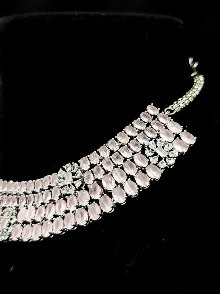 "A glamorous artificial diamond necklace with mint pink colored stone paired with chic earrings, perfect for bridal wear. This high-quality artificial diamond jewelry set is the ideal choice for modern brides looking for a budget-friendly option with timeless sparkle." Reception-ready look featuring a statement American diamond jewelry set.