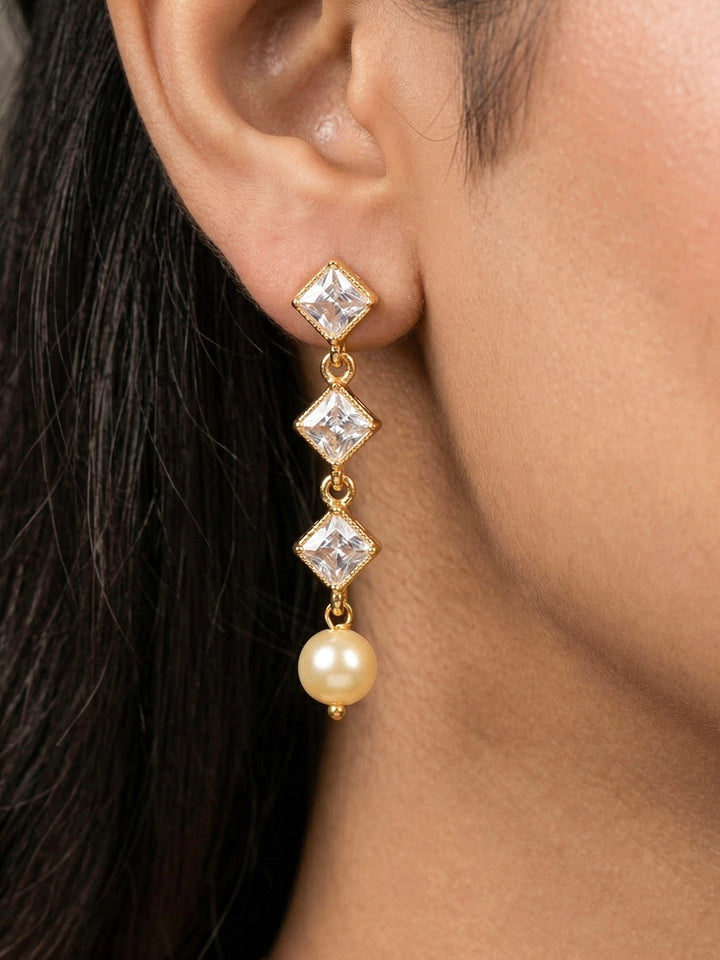 Close-up of a woman wearing an ornate traditional (Gold Polish) Collar jewellery set and earrings with American Diamond Polki and Pearls. Elegant festive look with a high-quality imitation American diamond necklace set. Festive Diwali outfit styled with an American diamond artificial necklace.