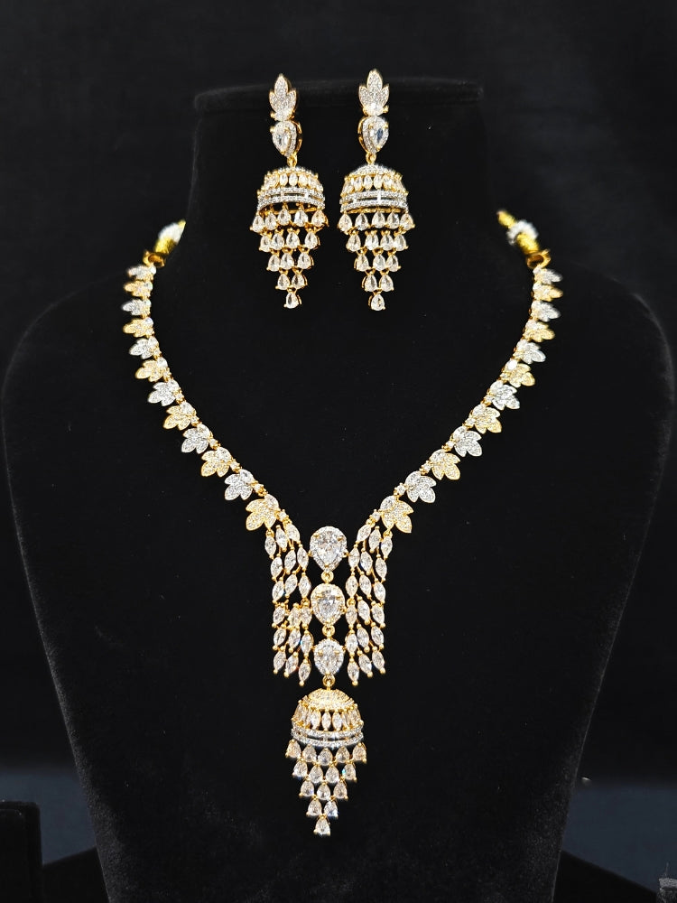 Close-up of an ornate Western American Diamond gold & White Collar jewellery set and earrings with American Diamond. Party wear outfit completed with a lightweight American diamond necklace. Elegant Cocktail and Party jewelry look featuring a premium artificial American diamond necklace.