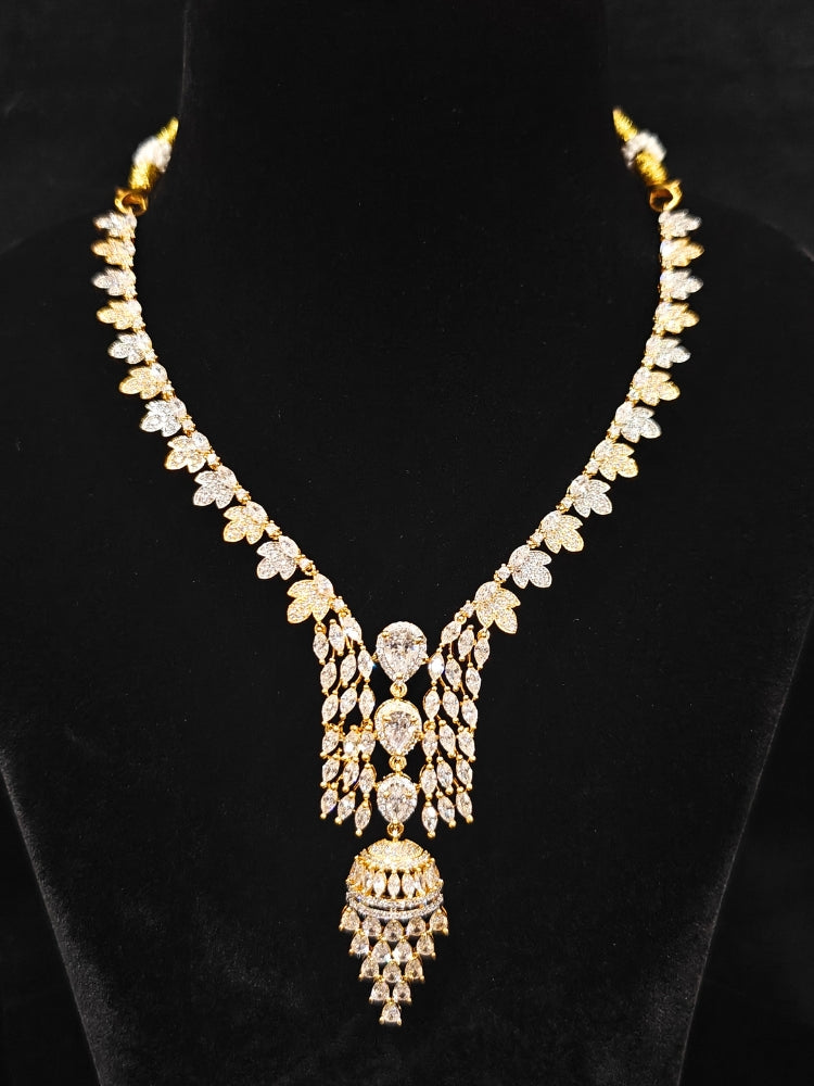 Close-up of an ornate Western American Diamond gold & White Collar jewellery set and earrings with American Diamond. Party wear outfit completed with a lightweight American diamond necklace. Elegant Cocktail and Party jewelry look featuring a premium artificial American diamond necklace.