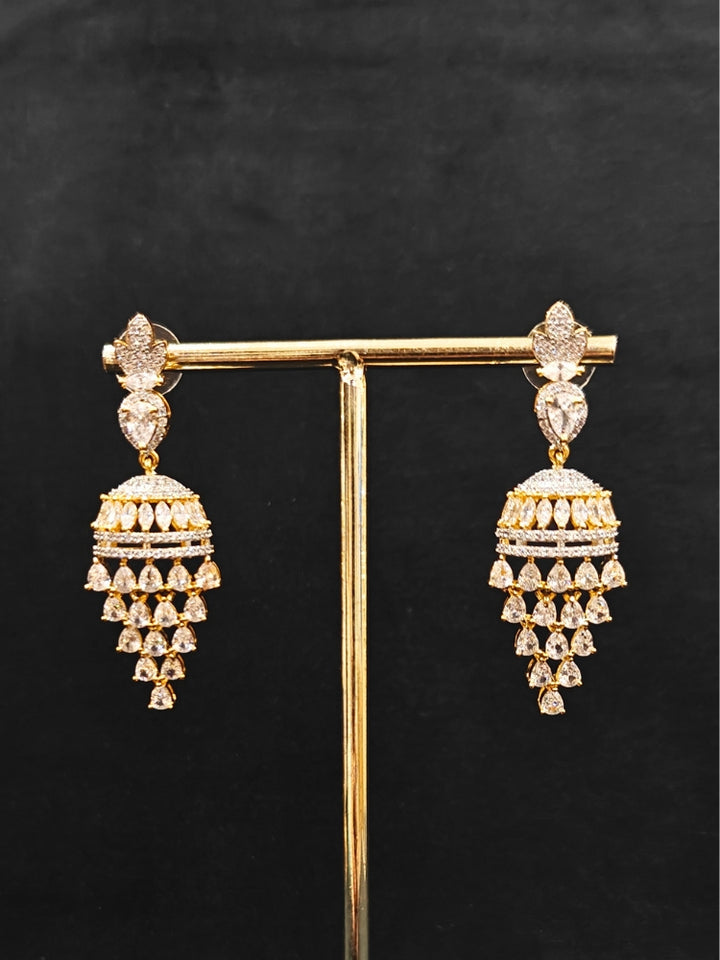 Close-up of an ornate Western American Diamond gold & White Collar jewellery set and earrings with American Diamond. Party wear outfit completed with a lightweight American diamond necklace. Elegant Cocktail and Party jewelry look featuring a premium artificial American diamond necklace.