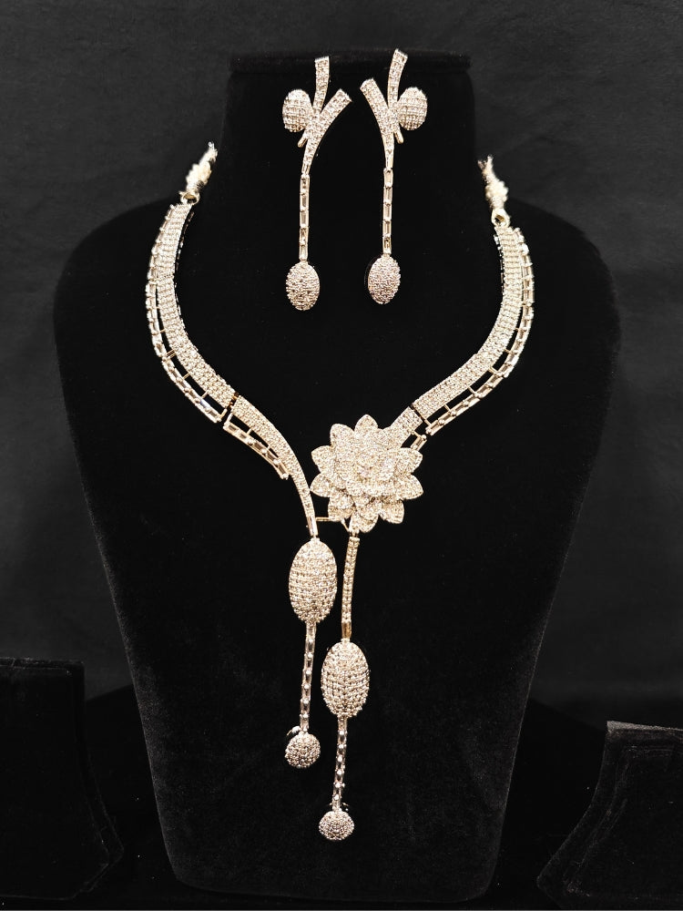 Close-up of an ornate  Western American Diamond Silver Collar jewellery set and earrings with American Diamond. Reception-ready look completed with American Diamond artificial jewelry set. Close-up of American diamond Necklace styled for a reception party.