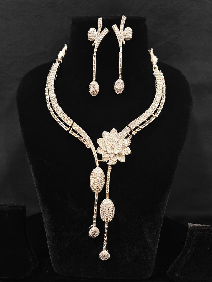 Close-up of an ornate  Western American Diamond Silver Collar jewellery set and earrings with American Diamond. Reception-ready look completed with American Diamond artificial jewelry set. Close-up of American diamond Necklace styled for a reception party.