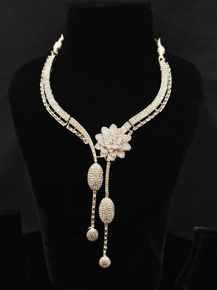 Close-up of an ornate  Western American Diamond Silver Collar jewellery set and earrings with American Diamond. Reception-ready look completed with American Diamond artificial jewelry set. Close-up of American diamond Necklace styled for a reception party.