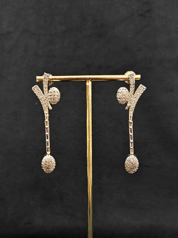 Close-up of an ornate  Western American Diamond Silver Collar jewellery set and earrings with American Diamond. Reception-ready look completed with American Diamond artificial jewelry set. Close-up of American diamond Necklace styled for a reception party.