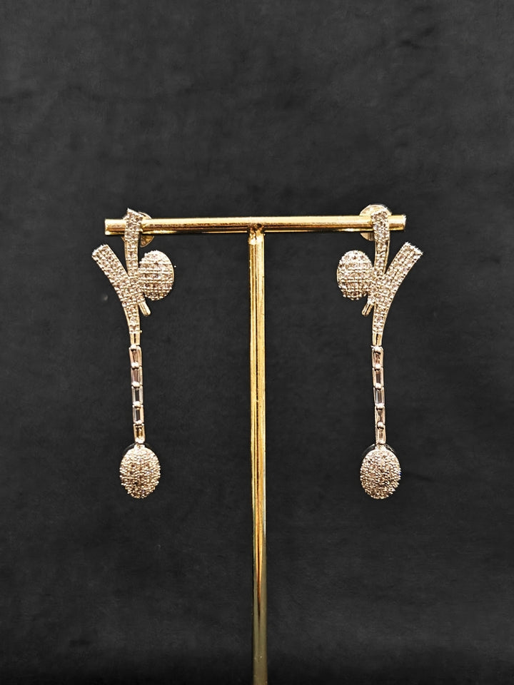 Close-up of an ornate  Western American Diamond Silver Collar jewellery set and earrings with American Diamond. Reception-ready look completed with American Diamond artificial jewelry set. Close-up of American diamond Necklace styled for a reception party.