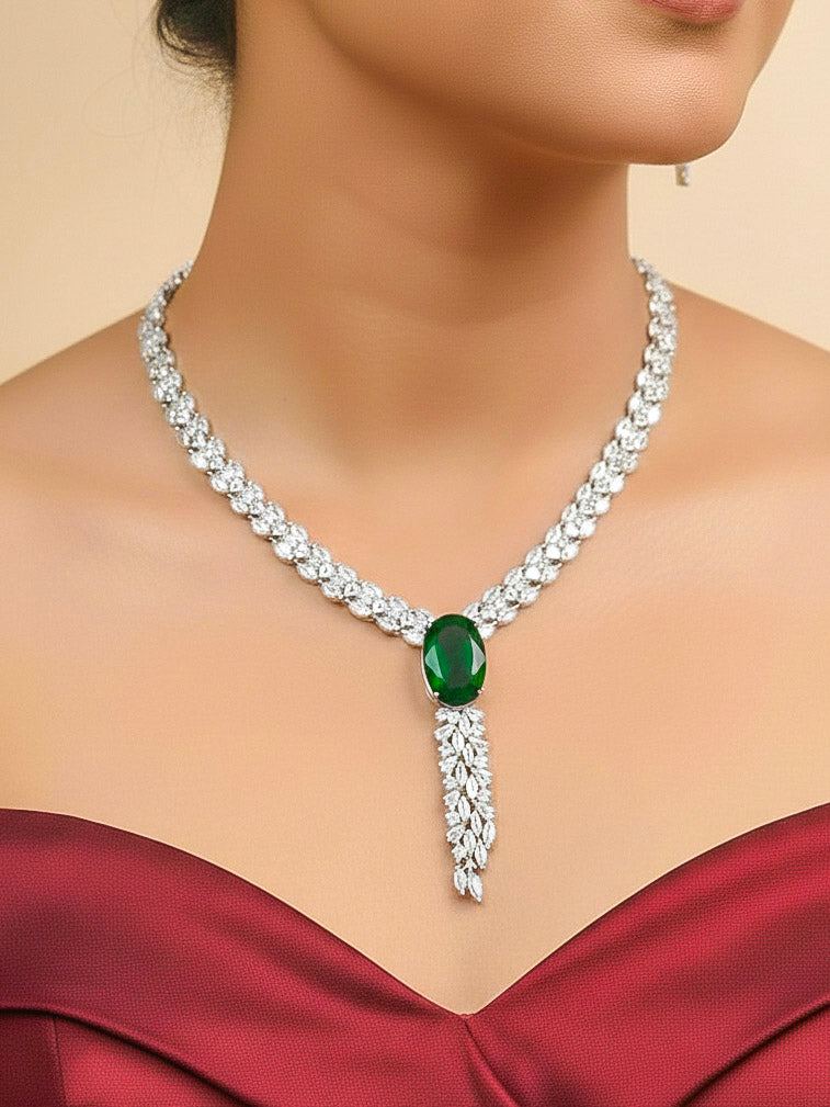 Close-up of a woman wearing an ornate Western Dark Green (Silver Polish) Collar Diamond jewellery set and earrings with Dark Green Colored Stone and American Diamond. Party wear outfit completed with a lightweight American diamond necklace.
Perfect American Diamond necklace set for Cocktail Party and festivals.