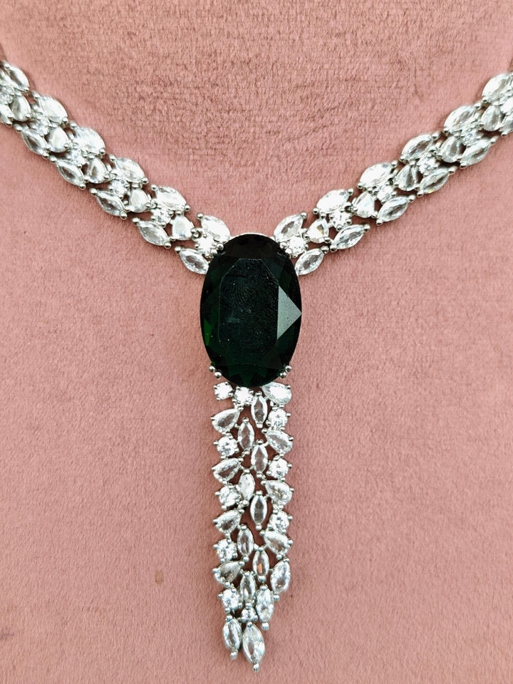 Close-up of an ornate Western Dark Green (Silver Polish) Collar Diamond jewellery set and earrings with Dark Green Colored Stone and American Diamond. Party wear outfit completed with a lightweight American diamond necklace.
Perfect American Diamond necklace set for Cocktail Party and festivals.