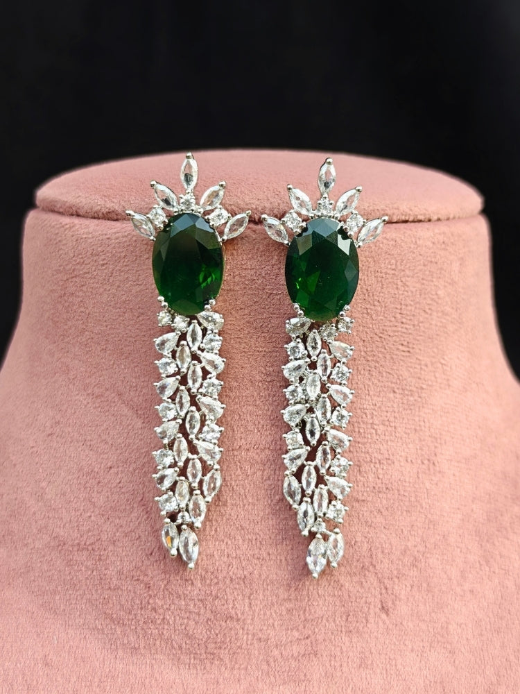 Close-up of an ornate Western Dark Green (Silver Polish) Collar Diamond jewellery set and earrings with Dark Green Colored Stone and American Diamond. Party wear outfit completed with a lightweight American diamond necklace.
Perfect American Diamond necklace set for Cocktail Party and festivals.