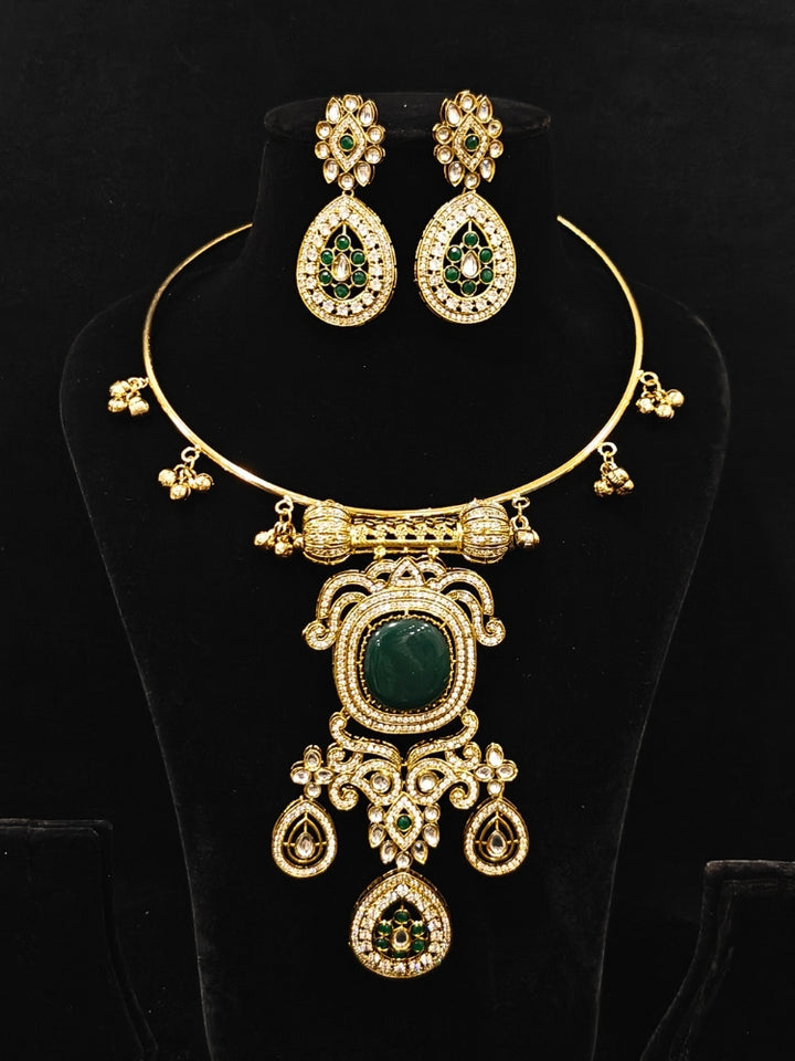 Close-up of an ornate Traditional Dark Green Diamond (Mehendi gold Polish) Hasli jewellery set and earrings with American Diamond and Dark Green Colored Stones. A luxury American diamond necklace set styled beautifully for a wedding guest look in India. Elegant festive look with a high-quality imitation American diamond necklace set.