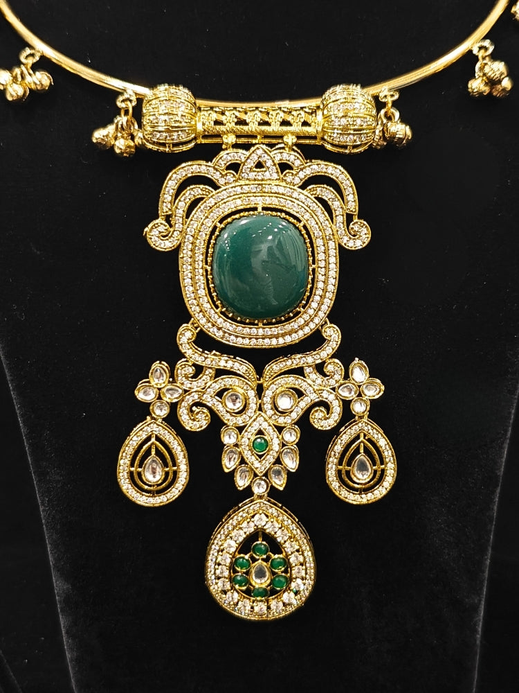Close-up of an ornate Traditional Dark Green Diamond (Mehendi gold Polish) Hasli jewellery set and earrings with American Diamond and Dark Green Colored Stones. A luxury American diamond necklace set styled beautifully for a wedding guest look in India. Elegant festive look with a high-quality imitation American diamond necklace set.