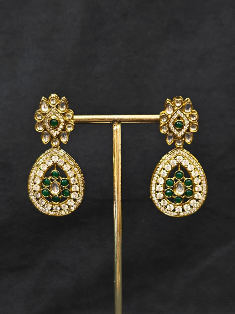Close-up of an ornate Traditional Dark Green Diamond (Mehendi gold Polish) Hasli jewellery set and earrings with American Diamond and Dark Green Colored Stones. A luxury American diamond necklace set styled beautifully for a wedding guest look in India. Elegant festive look with a high-quality imitation American diamond necklace set.