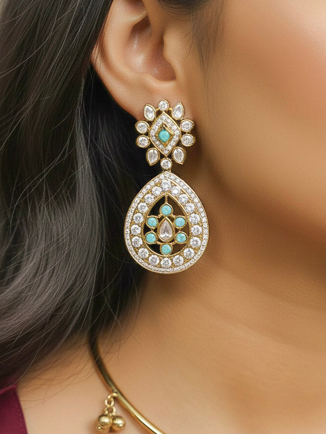 Close-up of a woman wearing an ornate Traditional Mint Blue Diamond (Mehendi gold Polish) Hasli jewellery set and earrings with American Diamond and Mint Blue Colored Stones. A woman wearing a luxury American diamond necklace set styled beautifully for a wedding guest look in India. Elegant festive look with a high-quality imitation American diamond necklace set.