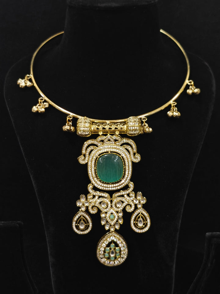 Close-up of an ornate Traditional Mint Blue Diamond (Mehendi gold Polish) Hasli jewellery set and earrings with American Diamond and Mint Blue Colored Stones. A  luxury American diamond necklace set styled beautifully for a wedding guest look in India. Elegant festive look with a high-quality imitation American diamond necklace set.