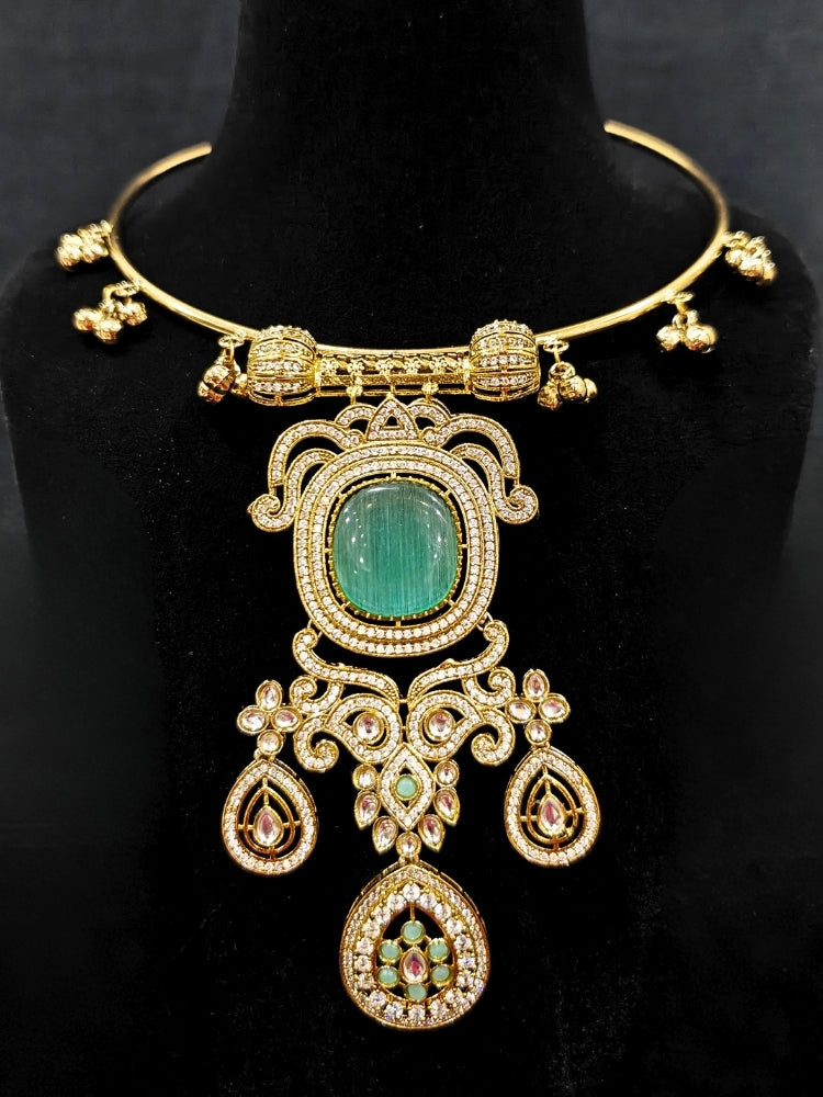 Close-up of an ornate Traditional Mint Green Diamond (Mehendi gold Polish) Hasli jewellery set and earrings with American Diamond and Mint Green Colored Stones. A luxury American diamond necklace set styled beautifully for a wedding guest look in India. Elegant festive look with a high-quality imitation American diamond necklace set.