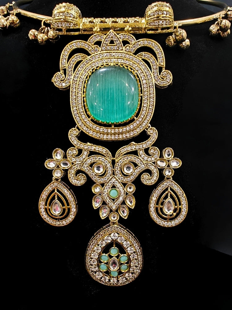 Close-up of an ornate Traditional Mint Green Diamond (Mehendi gold Polish) Hasli jewellery set and earrings with American Diamond and Mint Green Colored Stones. A luxury American diamond necklace set styled beautifully for a wedding guest look in India. Elegant festive look with a high-quality imitation American diamond necklace set.