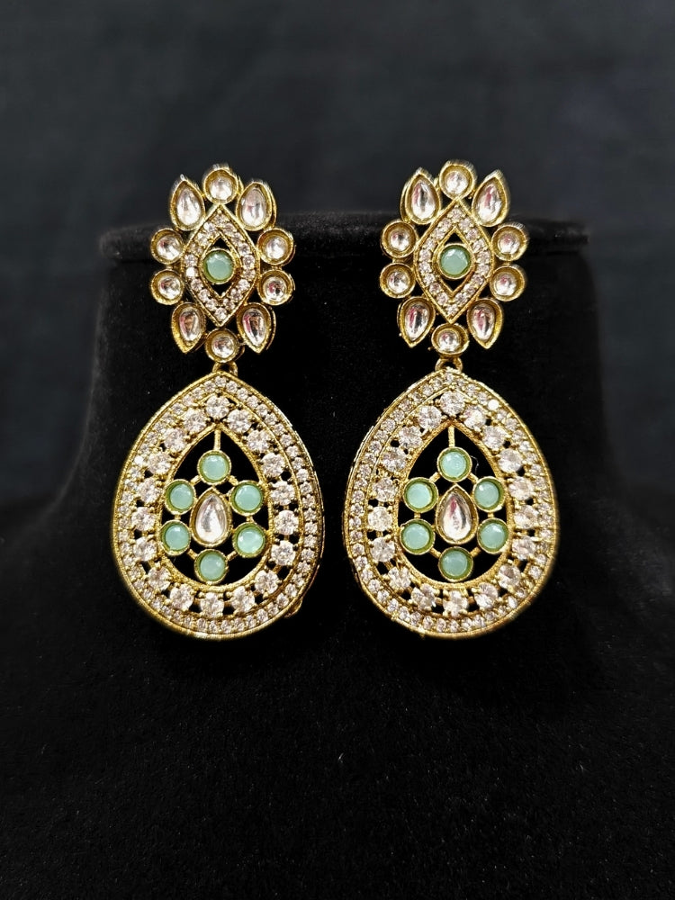 Close-up of an ornate Traditional Mint Green Diamond (Mehendi gold Polish) Hasli jewellery set and earrings with American Diamond and Mint Green Colored Stones. A luxury American diamond necklace set styled beautifully for a wedding guest look in India. Elegant festive look with a high-quality imitation American diamond necklace set.