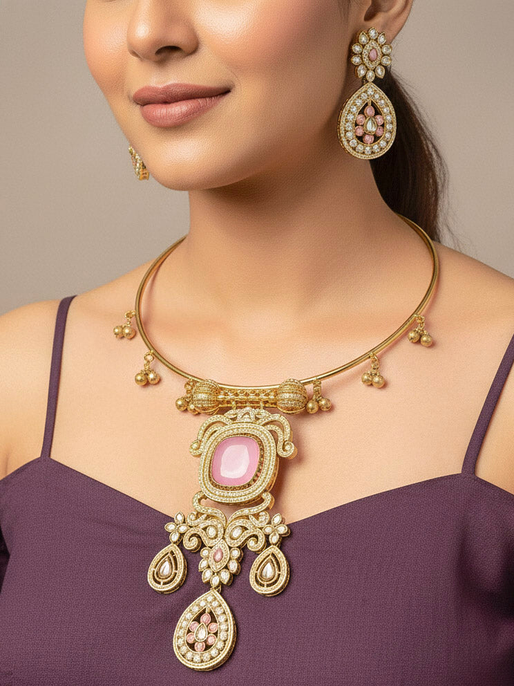 A woman with long dark hair wears a black top and the Lupin Mint Pink Necklace Set, featuring ornate ethnic jewelry with mint pink accents and matching earrings. The hasli necklace set is made in mehendi polish, along with mint pink stones and american diamonds. 