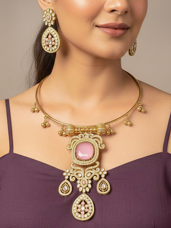 A woman with long dark hair wears a black top and the Lupin Mint Pink Necklace Set, featuring ornate ethnic jewelry with mint pink accents and matching earrings. The hasli necklace set is made in mehendi polish, along with mint pink stones and american diamonds. 