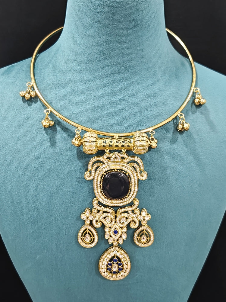 Close-up of an ornate Traditional Navy Blue Diamond (Mehendi gold Polish) Hasli jewellery set and earrings with American Diamond and Navy Blue Colored Stones. A  luxury American diamond necklace set styled beautifully for a wedding guest look in India. Elegant festive look with a high-quality imitation American diamond necklace set.
