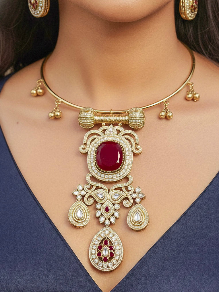 Close-up of a woman wearing an ornate Traditional Red Diamond (Mehendi gold Polish) Hasli jewellery set and earrings with American Diamond and Red Colored Stones. A woman wearing a luxury American diamond necklace set styled beautifully for a wedding guest look in India. Elegant festive look with a high-quality imitation American diamond necklace set.