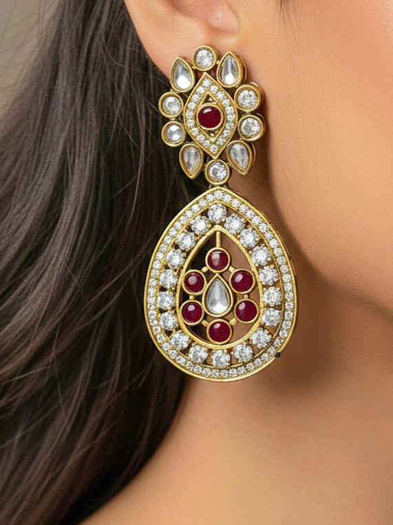 Close-up of a woman wearing an ornate Traditional Red Diamond (Mehendi gold Polish) Hasli jewellery set and earrings with American Diamond and Red Colored Stones. A woman wearing a luxury American diamond necklace set styled beautifully for a wedding guest look in India. Elegant festive look with a high-quality imitation American diamond necklace set.
