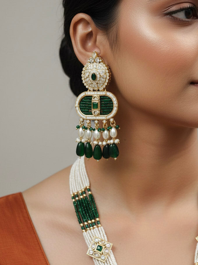 Close-up of a woman wearing an ornate traditional Green Rajwadi gold Long jewellery set and earrings  with  Pearls, Tumble Beads, Meenakari, Moissanite Kundan, Bandhai Work and Hydro Crystals. Woman wearing a Rajwadi necklace for a reception function. Elegant  look with a traditional Rajwadi artificial necklace.