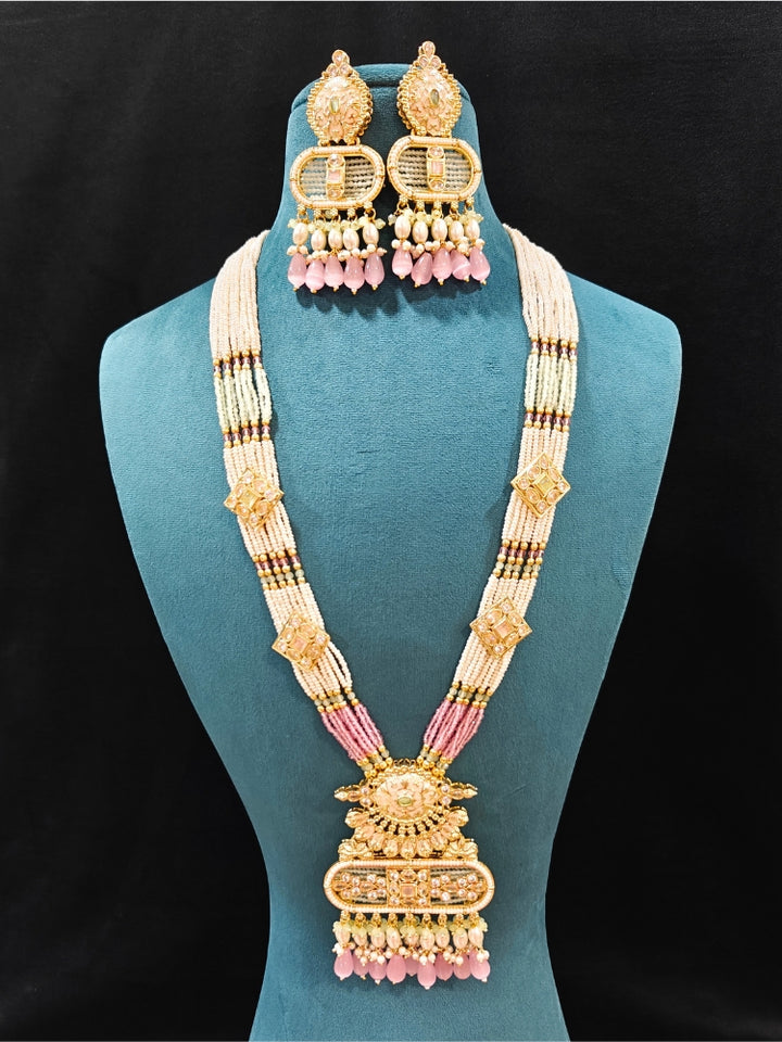 Close-up of an ornate traditional Mint Pink and Green Rajwadi gold Long jewellery set and earrings  with  Pearls, Tumble Beads, Meenakari, Moissanite Kundan, Bandhai Work and Hydro Crystals. Close-up of a handcrafted Rajwadi artificial jewelry set . Elegant  look with a traditional Rajwadi artificial necklace. Close-up of a premium Rajwadi artificial necklace under 10000.