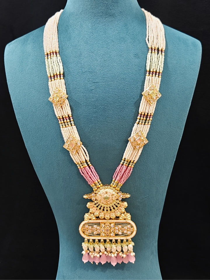 Close-up of an ornate traditional Mint Pink and Green Rajwadi gold Long jewellery set and earrings  with  Pearls, Tumble Beads, Meenakari, Moissanite Kundan, Bandhai Work and Hydro Crystals. Close-up of a handcrafted Rajwadi artificial jewelry set . Elegant  look with a traditional Rajwadi artificial necklace. Close-up of a premium Rajwadi artificial necklace under 10000.