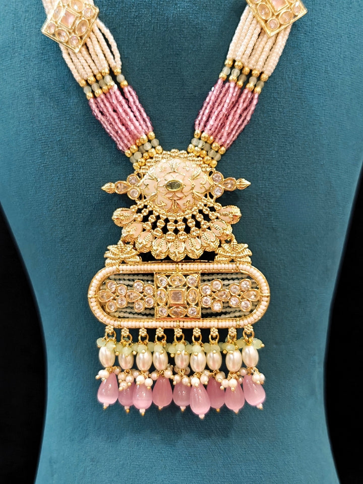 Close-up of an ornate traditional Mint Pink and Green Rajwadi gold Long jewellery set and earrings  with  Pearls, Tumble Beads, Meenakari, Moissanite Kundan, Bandhai Work and Hydro Crystals. Close-up of a handcrafted Rajwadi artificial jewelry set . Elegant  look with a traditional Rajwadi artificial necklace. Close-up of a premium Rajwadi artificial necklace under 10000.