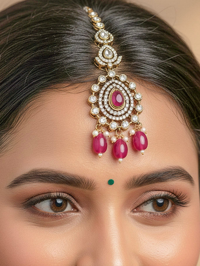 Close-up of a woman wearing an ornate traditional Magenta Diamond Collar Layered jewellery set and earrings and maangtikka with Kundan, American Diamonds, Tumble stones, Black Polish and Colored Stones. A woman wearing a luxury American diamond necklace set styled beautifully for a wedding guest look in India. Close-up of a bridal look featuring an anti-tarnish American diamond artificial necklace.