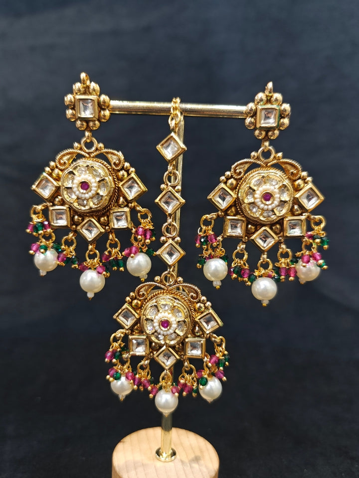Close-up of an ornate traditional Rajwadi and Heritage gold Choker jewellery set and earrings and maangtikka with Pearls, Hydro Crystal and Moissanite Kundan. Close-up of a premium Rajwadi artificial necklace. Traditional Indian bridal look completed with a heritage artificial jewelry set.