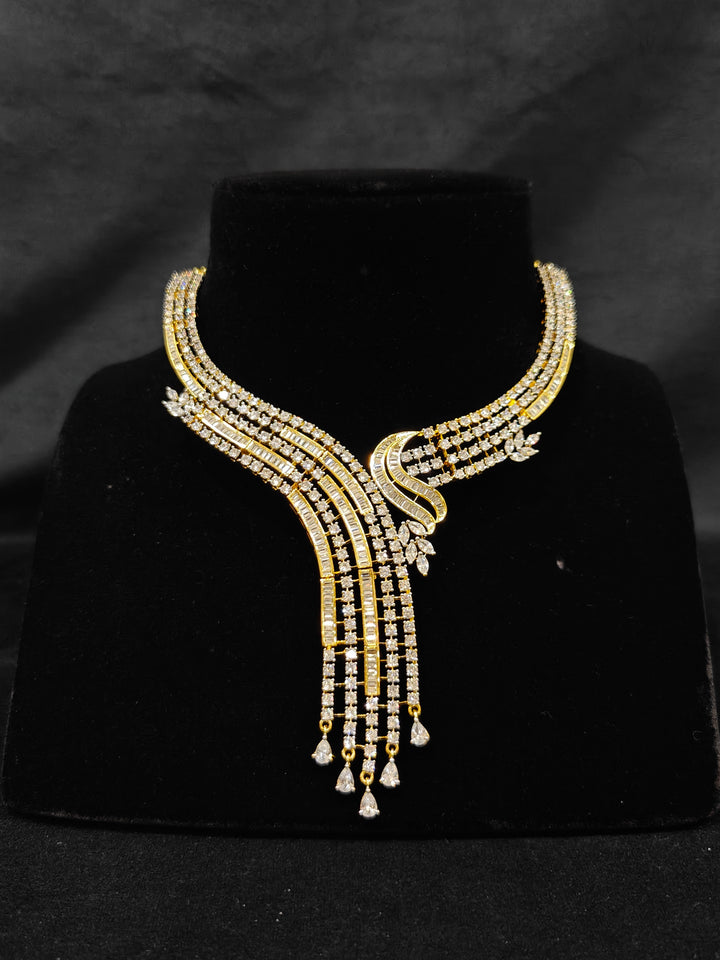 Close-up of an ornate Western gold Diamond Collar jewellery set and earrings with American Diamond. Close-up of a cocktail party look featuring a premium American diamond necklace. Perfect Necklace Set for Party wear.