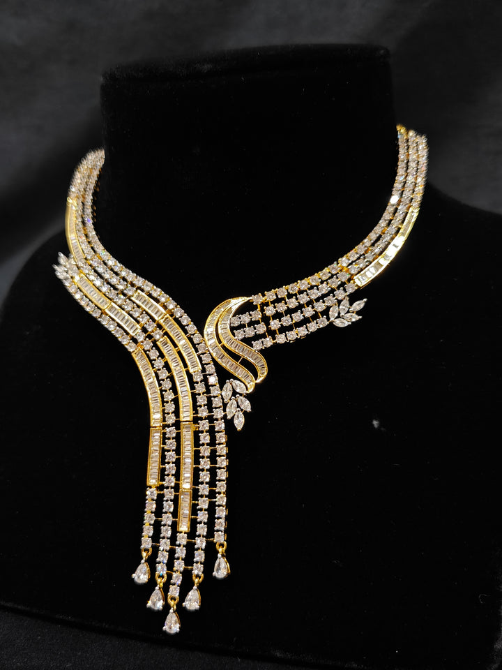 Close-up of an ornate Western gold Diamond Collar jewellery set and earrings with American Diamond. Close-up of a cocktail party look featuring a premium American diamond necklace. Perfect Necklace Set for Party wear.