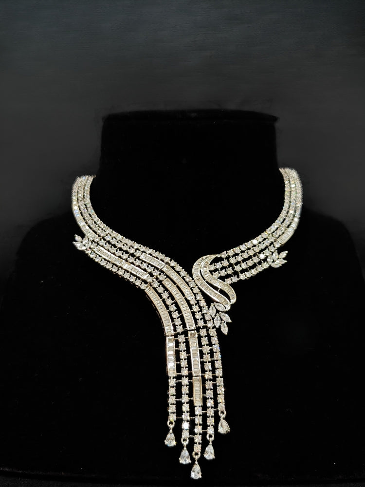 Close-up of an ornate Western Silver Diamond Collar jewellery set and earrings with American Diamond. Close-up of a cocktail party look featuring a premium American diamond necklace. A luxury American diamond necklace set styled beautifully for a wedding guest look in India.