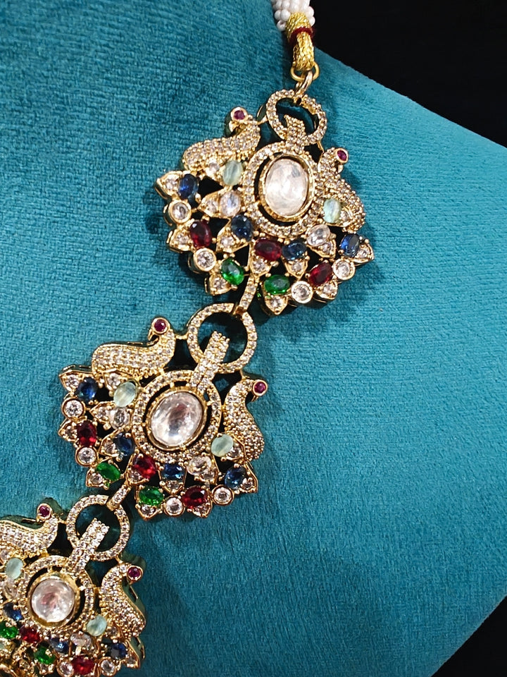 Close-up of an ornate traditional American diamond & Color stone gold jewellery set and earrings with American Diamond, Colored Stones, Kundan and Polki. A graceful trending American diamond necklace for a 2026 wedding celebration.
