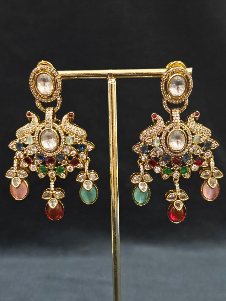 Close-up of an ornate traditional American diamond & Color stone gold jewellery set and earrings with American Diamond, Colored Stones, Kundan and Polki. A graceful trending American diamond necklace for a 2026 wedding celebration.