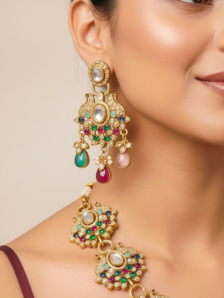 Close-up of a woman wearing an ornate traditional American diamond & Color stone gold jewellery set and earrings with American Diamond, Colored Stones, Kundan and Polki. A graceful trending American diamond necklace for a 2026 wedding celebration.