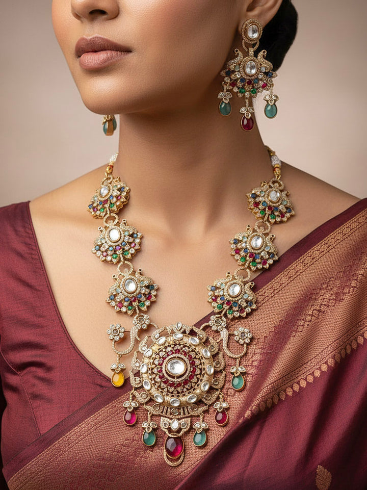 Close-up of a woman wearing an ornate traditional American diamond & Color stone gold jewellery set and earrings with American Diamond, Colored Stones, Kundan and Polki. A graceful trending American diamond necklace for a 2026 wedding celebration.