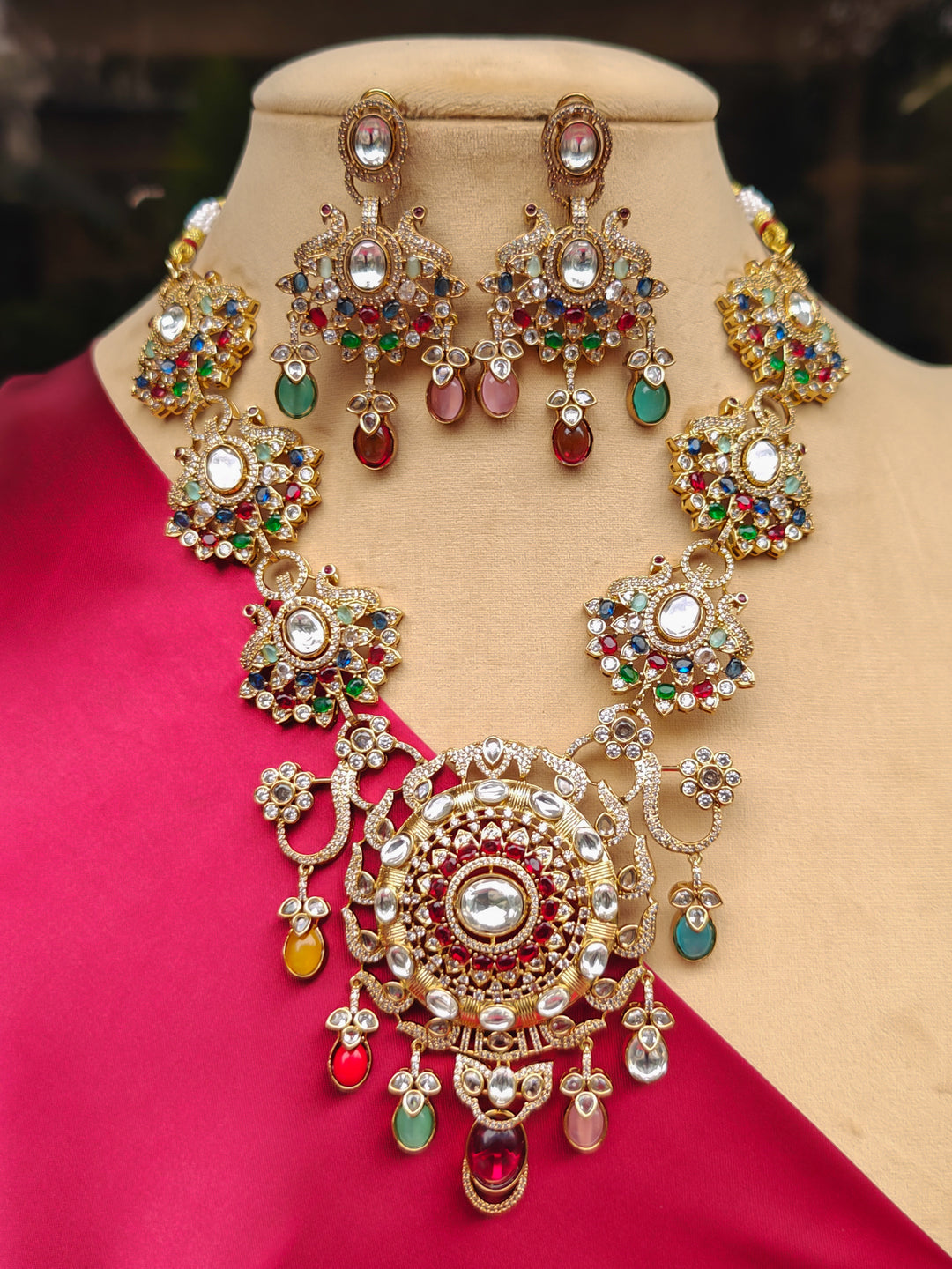 Close-up of an ornate traditional American diamond & Color stone gold jewellery set and earrings with American Diamond, Colored Stones, Kundan and Polki. A graceful trending American diamond necklace for a 2026 wedding celebration.