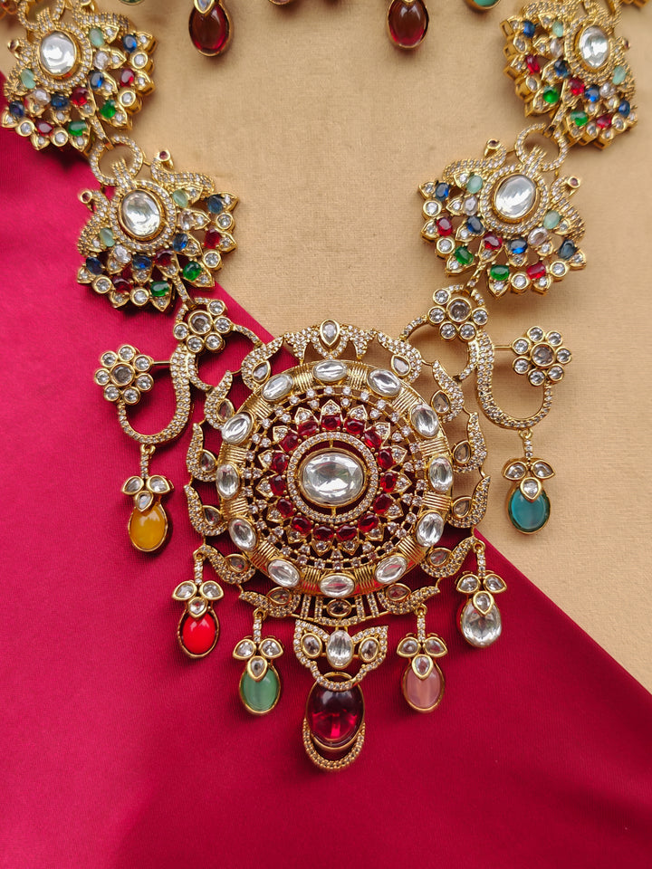 Close-up of an ornate traditional American diamond & Color stone gold jewellery set and earrings with American Diamond, Colored Stones, Kundan and Polki. A graceful trending American diamond necklace for a 2026 wedding celebration.